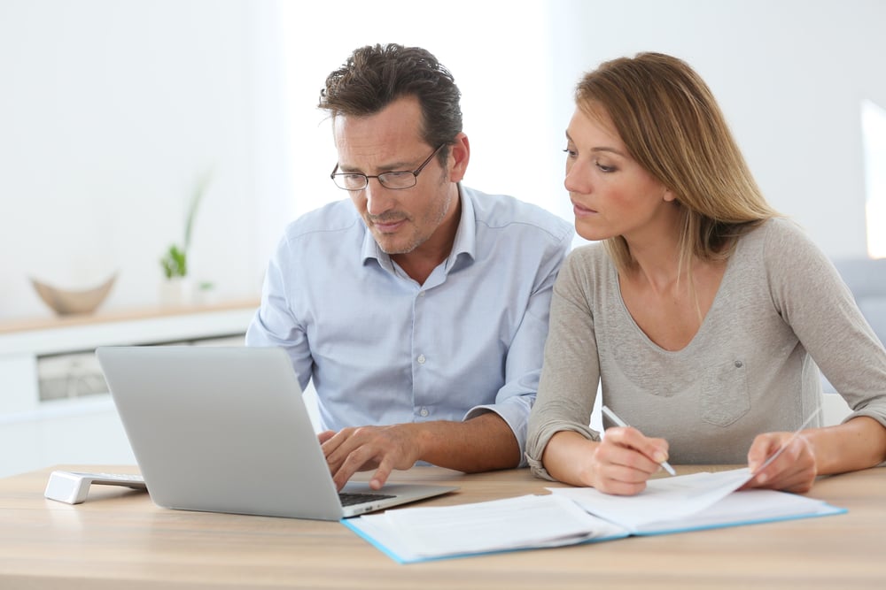 Couple sits at laptop using RealMe identity verification