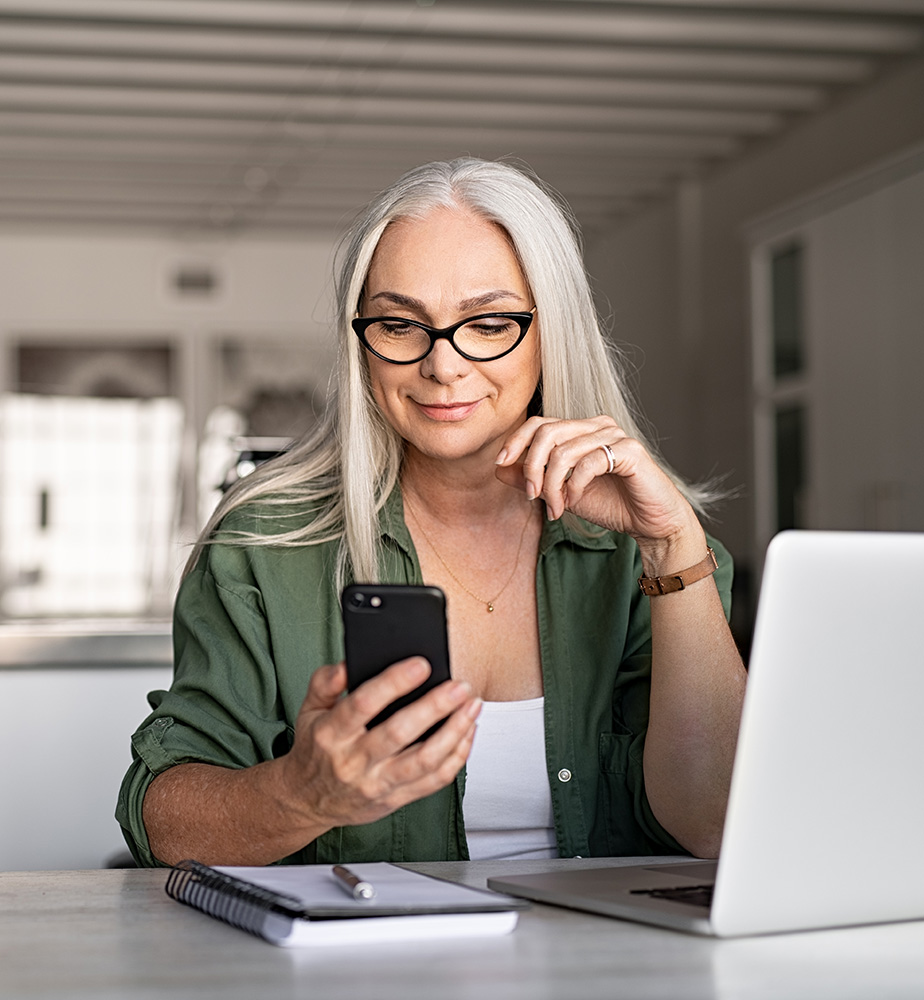 AML Compliance Officer checking her phone